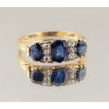 An 18ct yellow gold sapphire & diamond ring, with three oval cut sapphires alternating with two