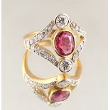 An 18ct yellow gold ruby & diamond ring with openwork setting, the oval cut ruby weighing