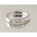 Property of a lady - an unmarked platinum diamond seven stone ring, the round brilliant cut diamonds