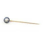 Property of a lady - a sapphire & pearl stickpin, with central pearl set within a ring of calibre