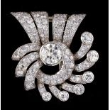 An impressive diamond ribbon brooch, signed J. Roca, the centre round brilliant cut diamond weighing