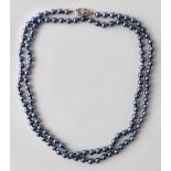 Property of a lady - a cultured black pearl single strand necklace, the one hundred & twenty-three