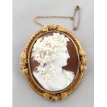Property of a lady - a Victorian oval shell cameo brooch depicting a classical lady with vine &