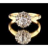 An 18ct yellow gold diamond cluster ring, the central round brilliant cut diamond approximately 0.