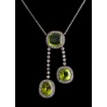 A peridot & paste tassel necklace, the three cushion cut peridots weighing a total of