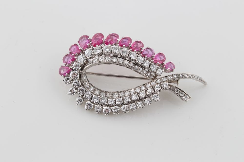 A fine white gold untreated Burmese ruby & diamond ribbon brooch, the eleven graduated pear shaped