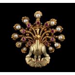 An early 19th century yellow gold cannetille peacock brooch, circa 1820, set with cut rubies &