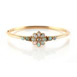 A late Victorian yellow gold opal & diamond hinged bangle, the flowerhead setting with a central old