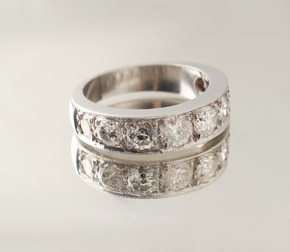 Property of a gentleman - an unmarked platinum eight stone diamond half eternity ring, the eight