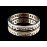 Property of a lady - an unmarked platinum or white gold diamond eternity ring, size J/K (see