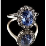 Property of a deceased estate - an unmarked synthetic sapphire & diamond ring, the oval cut clear