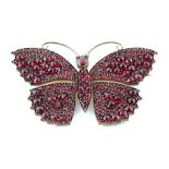 A large garnet butterfly brooch, with rose cut garnets & seed pearl eyes, 78mm across, approximately