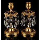 Property of a lady - a pair of late 19th century French ormolu or gilt brass candlestick table