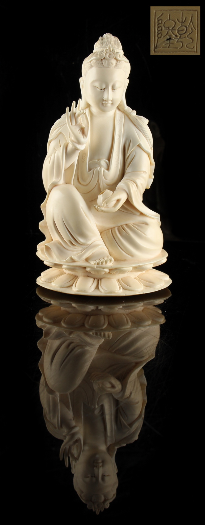 A Chinese carved ivory figure of Guanyin, 19th century, modelled seated on a double lotus base,