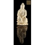 A Chinese carved ivory figure of Guanyin, 19th century, modelled seated on a double lotus base,