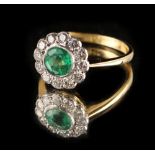 An 18ct yellow gold emerald & diamond cluster ring, the round cut emerald weighing approximately 1.0