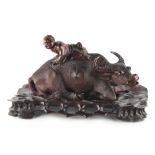 A late 19th / early 20th century Chinese carved hardwood model of a recumbent buffalo, on fitted