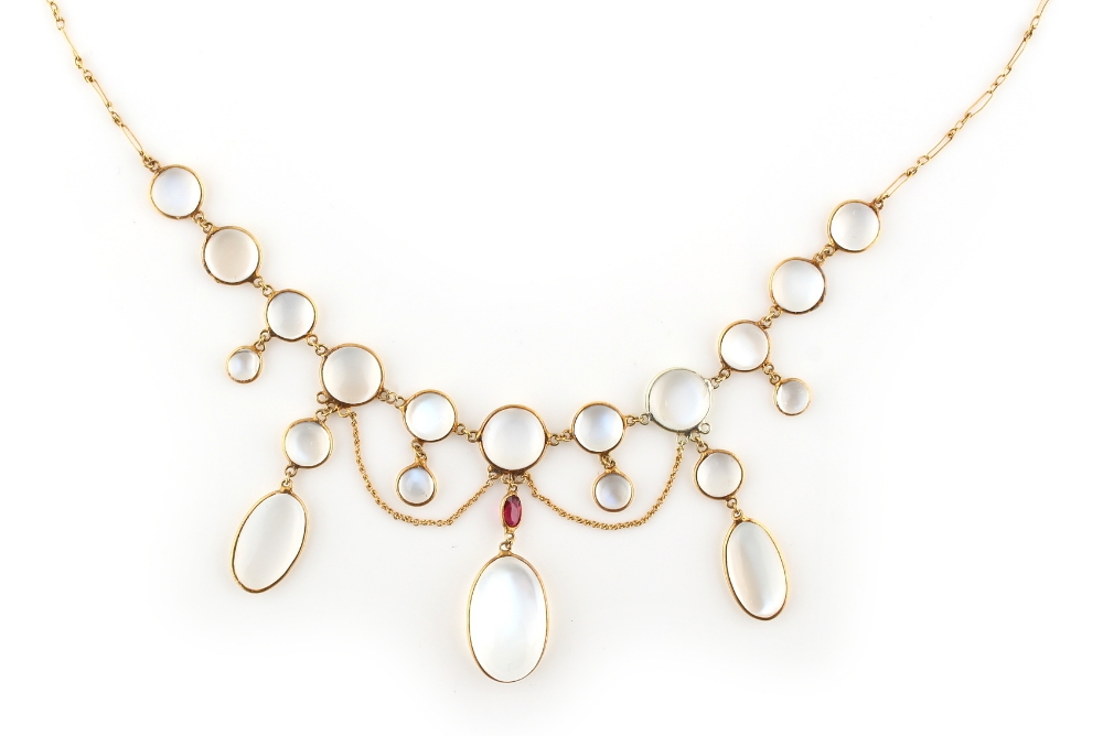 An unmarked yellow gold moonstone & ruby festoon necklace, 16ins. (40.5cms.) long (see