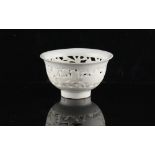 A Chinese Dehua blanc de Chine pierced bowl, 18th century, 3.45ins. (8.8cms.) diameter (see