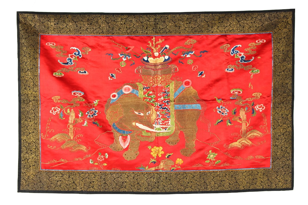 A late 19th / early 20th century Chinese embroidered scarlet silk panel depicting a caparisoned