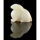 A Chinese carved very pale celadon model of a seated hare or rabbit, 2ins. (5.1cms.) long (see