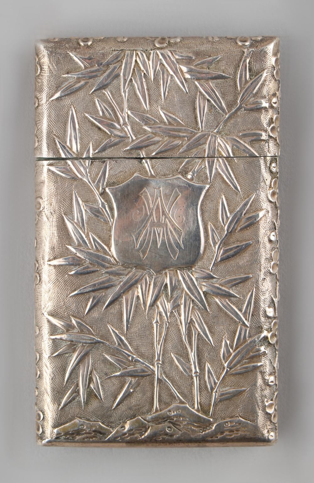 A late 19th / early 20th century Chinese silver card case, decorated in relief with a pagoda & - Image 2 of 2