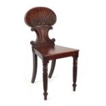 Property of a lady - an early 19th century Regency period mahogany hall chair with carved shell back