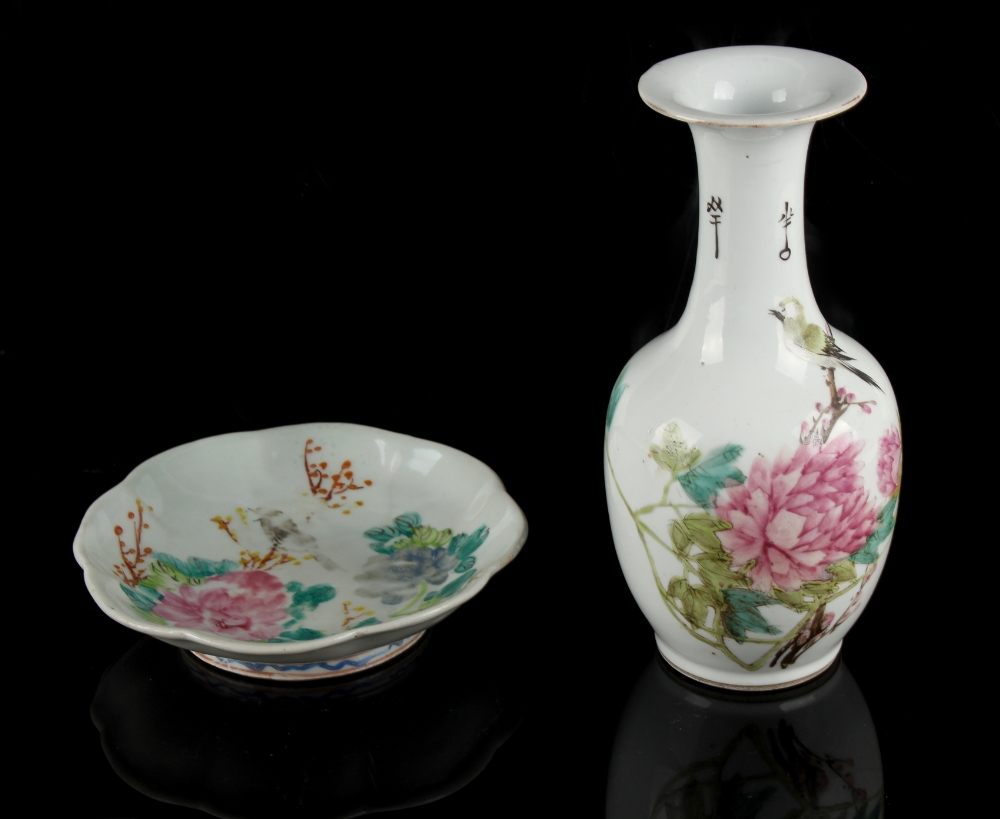 A Chinese famille rose bottle vase depicting a bird among peonies, 20th century, 8.6ins. (21.