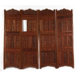 An Indian carved teak four panel screen (F/R) (see illustration).