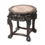 A late 19th / early 20th century Chinese carved hongmu stand with pink marble inset top, 19ins. (