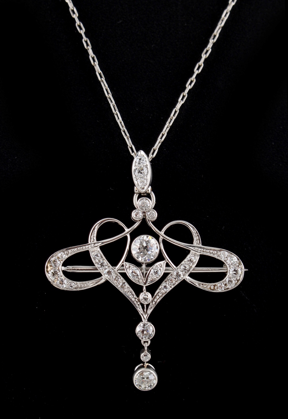 A Tiffany & Co. Belle Epoque diamond openwork brooch or pendant, on associated chain necklace,
