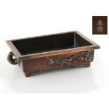 Property of a gentleman - a Japanese bronze rectangular planter, decorated in relief with a bird