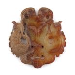 A Chinese carved jade pendant or plaque modelled as two birds, 2.55ins. (6.5cms.) high (see