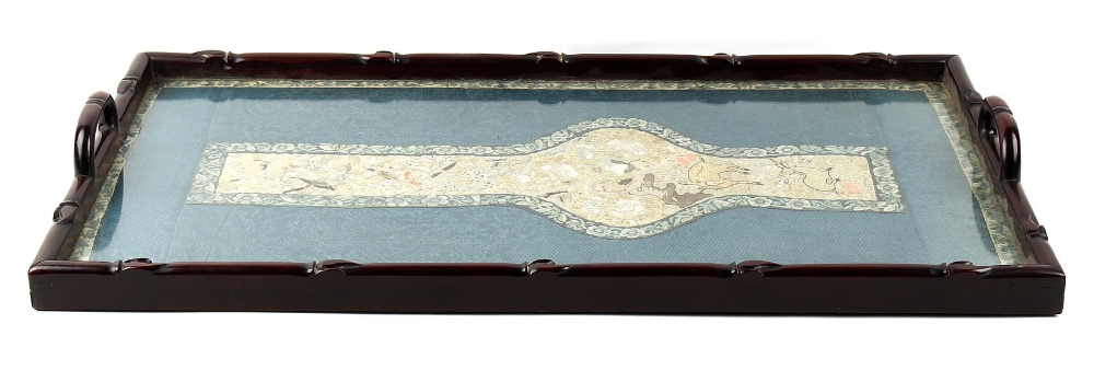 An early 20th century Chinese carved hongmu rectangular tray inset with an embroidered silk panel in