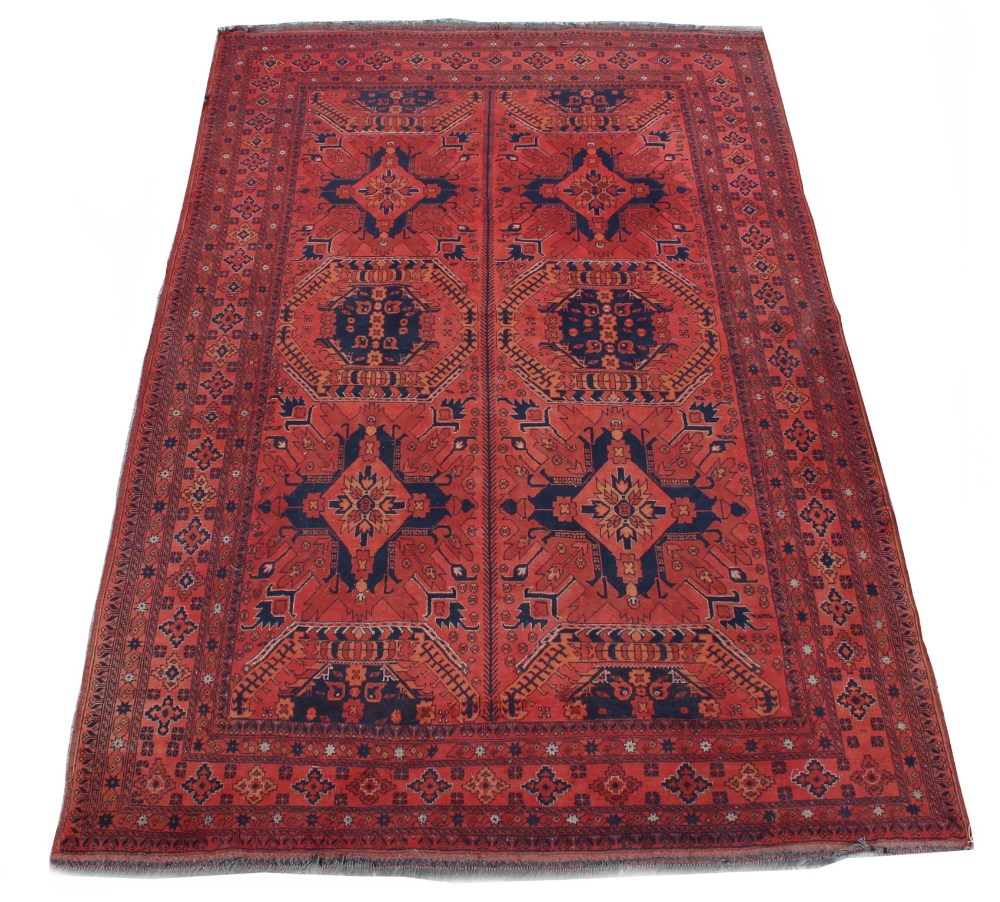 Property of a lady - a mid 20th century Turkoman carpet with red ground, 116 by 79ins. (295 by