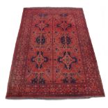 Property of a lady - a mid 20th century Turkoman carpet with red ground, 116 by 79ins. (295 by