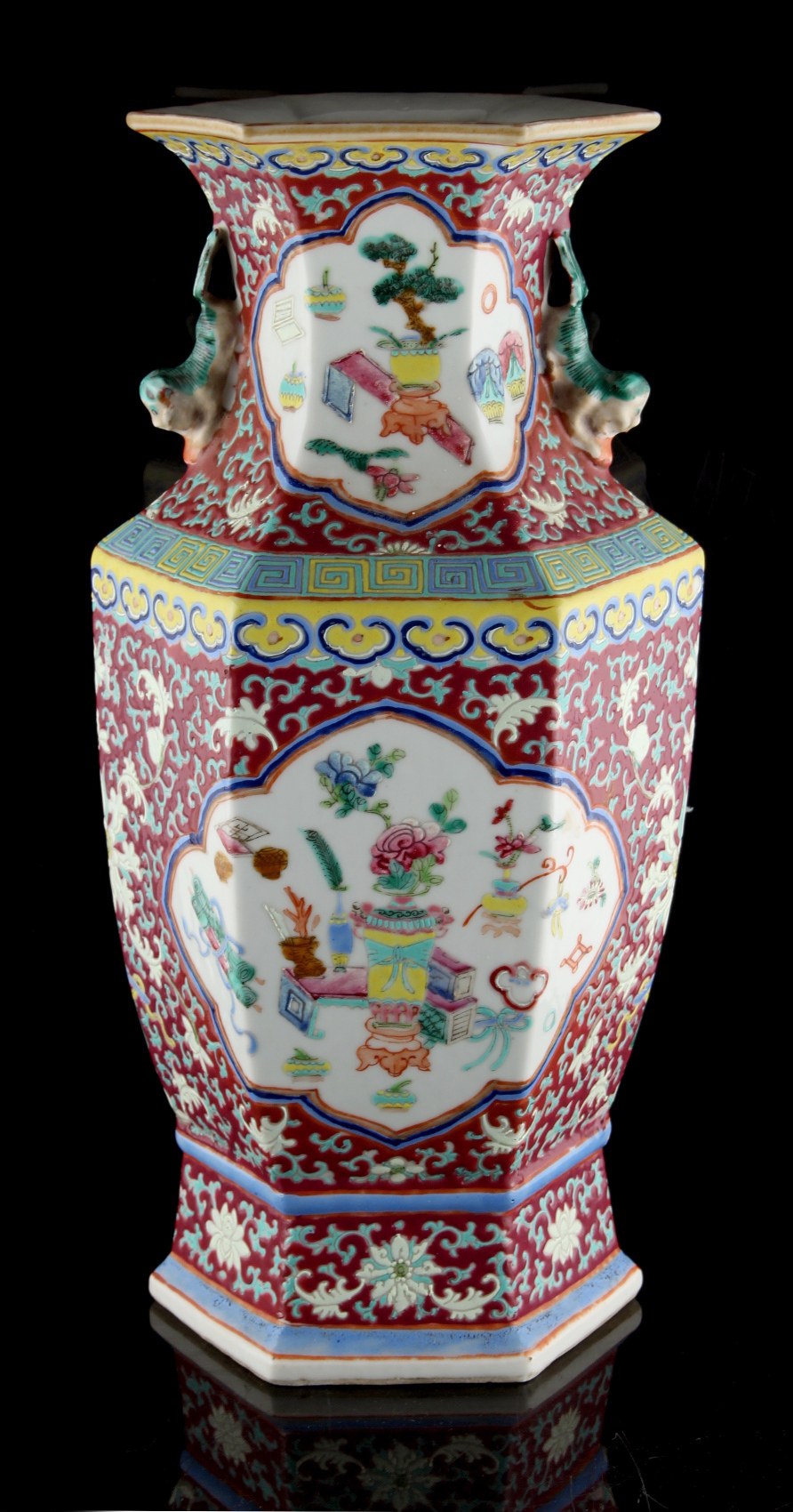 Property of a lady - a late 19th century Chinese ruby ground famille rose hexagonal vase, painted