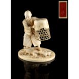 Property of a lady - a Japanese carved ivory okimono depicting a man holding a cage above