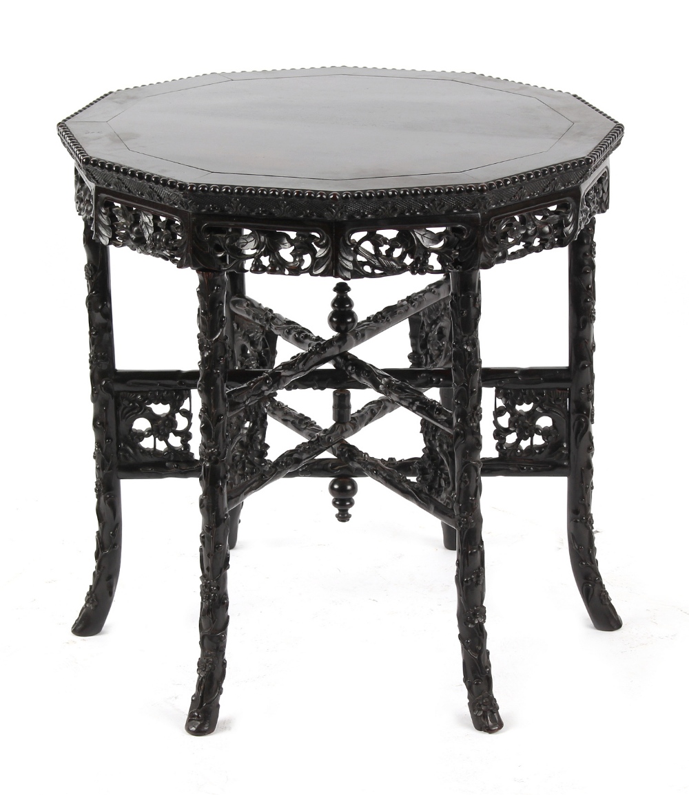 A late 19th / early 20th century Chinese carved hongmu dodecahedral table with folding six legged