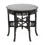 A late 19th / early 20th century Chinese carved hongmu dodecahedral table with folding six legged