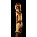 Property of a gentleman - an African tribal carved ivory figure of a standing man, probably Lega,