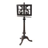 Property of a deceased estate - a Victorian ebonised duet music stand, with tripod base, losses (see