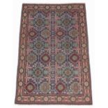 A Tabriz woollen hand-made rug with blue ground, 58 by 38ins. (147 by 97cms.)