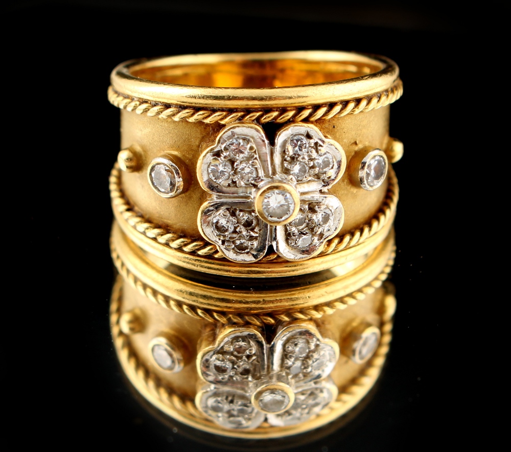 Property of a lady - an 18ct gold ring of tapering band form, set with a diamond flowerhead with a