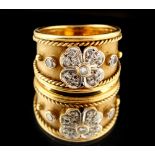 Property of a lady - an 18ct gold ring of tapering band form, set with a diamond flowerhead with a