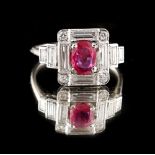 An Art Deco style unmarked platinum or white gold ruby & diamond ring, the oval cut untreated