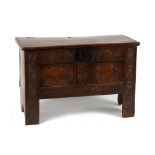 Property of a lady - a late 17th century oak coffer with carved two panel front, 36.5ins. (92cms.)