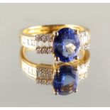 Property of a lady - a 14ct yellow gold tanzanite & diamond ring, the oval cut tanzanite weighing