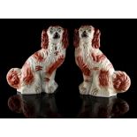 Property of a gentleman - a pair of Victorian Staffordshire models of seated spaniels with iron