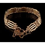 Property of a lady - a 9ct rose gold gate link bracelet with heart shaped clasp, with safety chain.